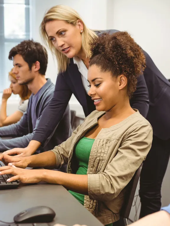 Students in a computer science lesson working from a computer.