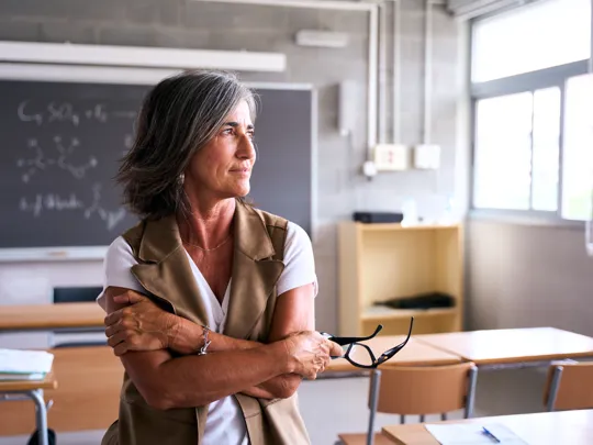 Teacher looking away in thought.