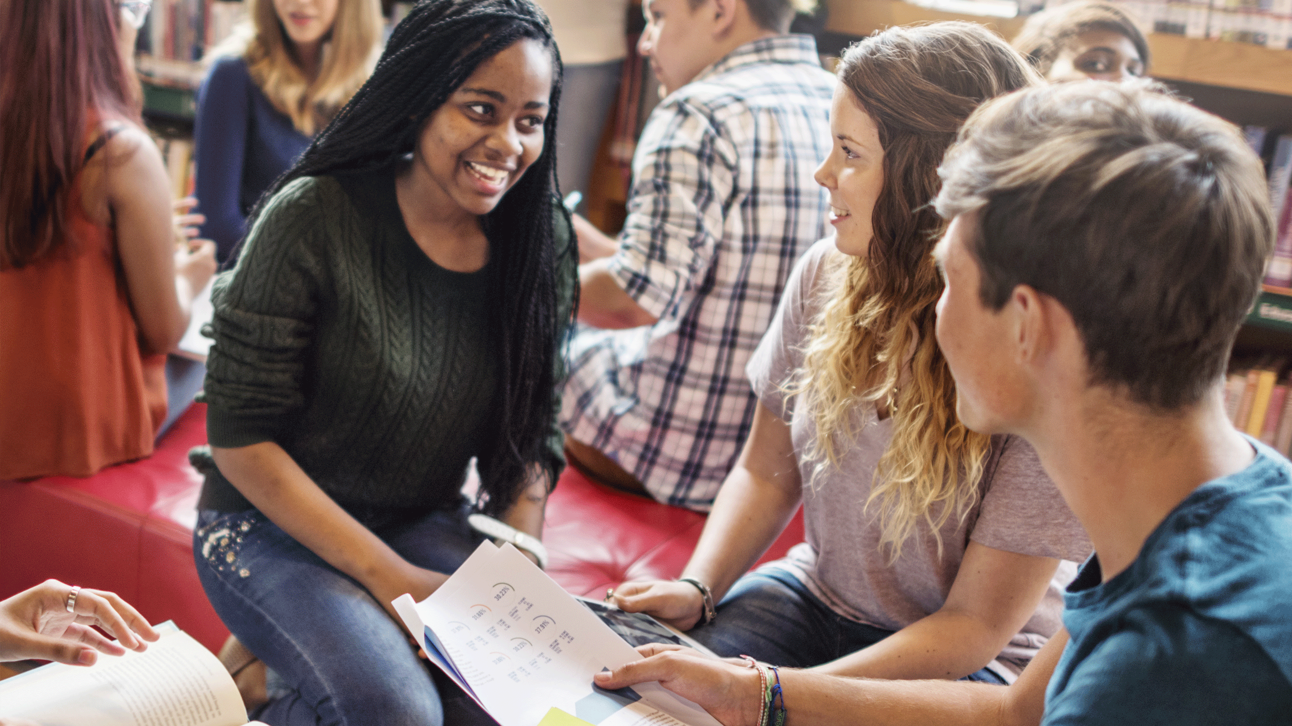Teacher speaking directly with two students.