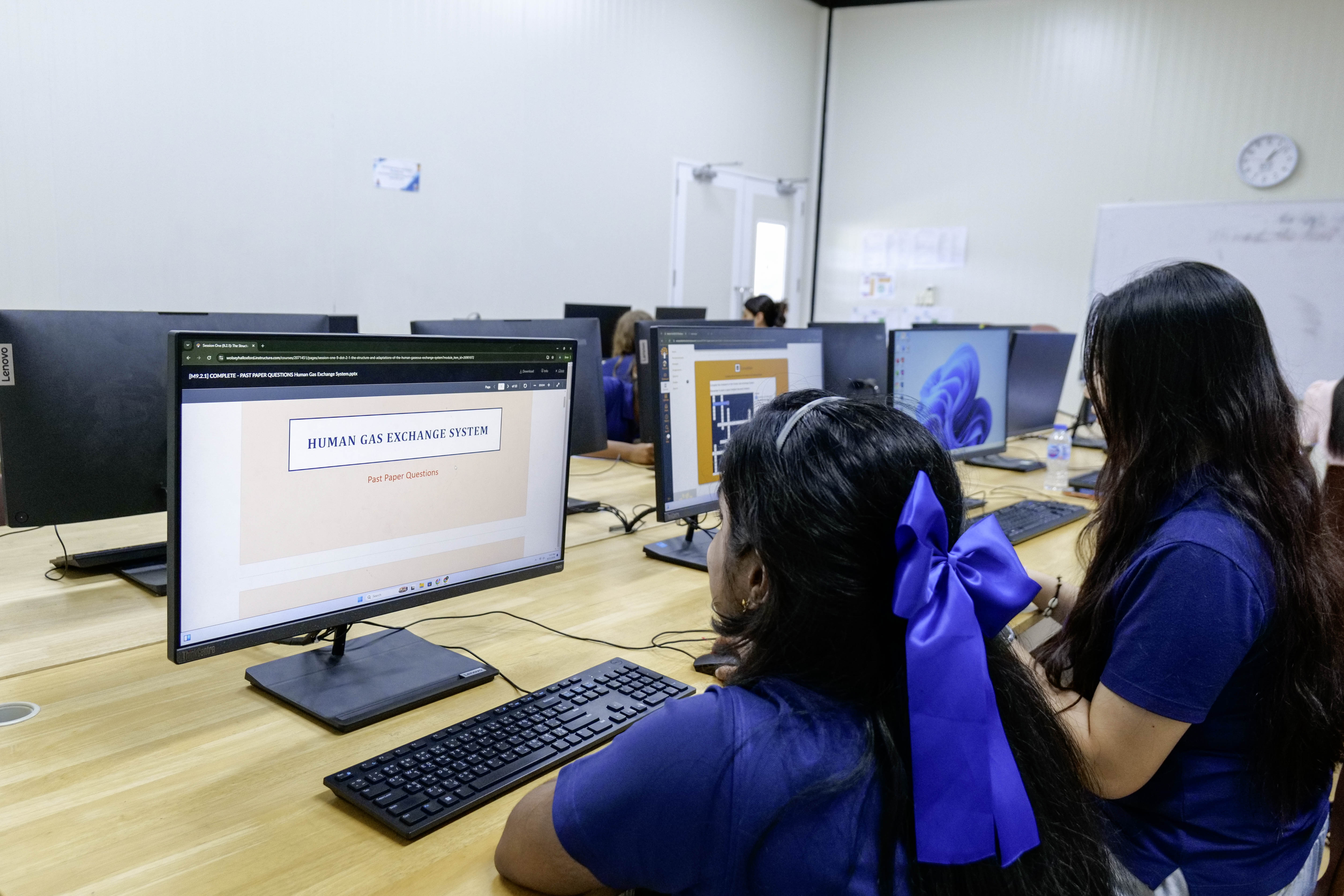 Photo of Windfield International School students studying on a computer.