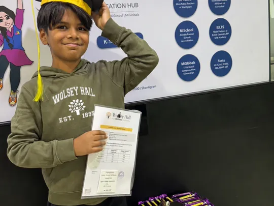 Student from the MI Education Hub wearing a green Wolsey Hall branded jumper.